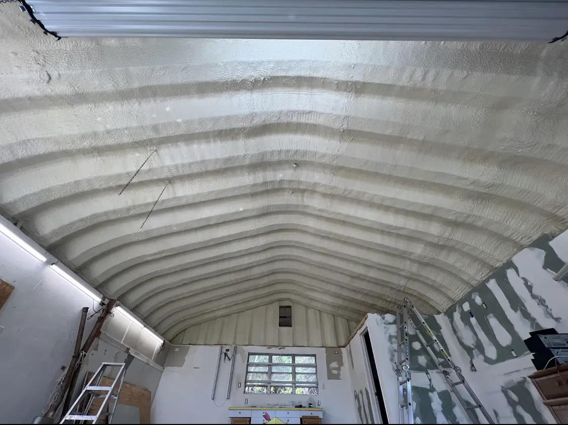 Spray polyurethane foam applied to the underside of a metal roof deck in Brewton